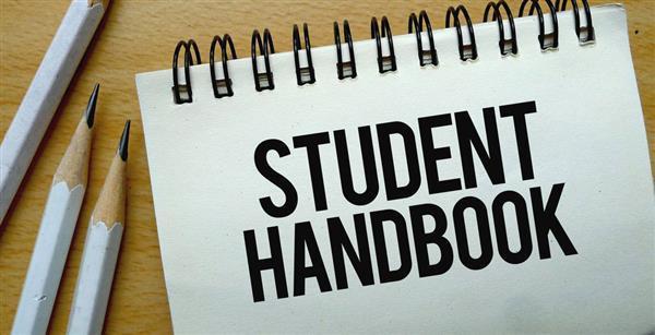 Image of notebook and pencils with student handbook title