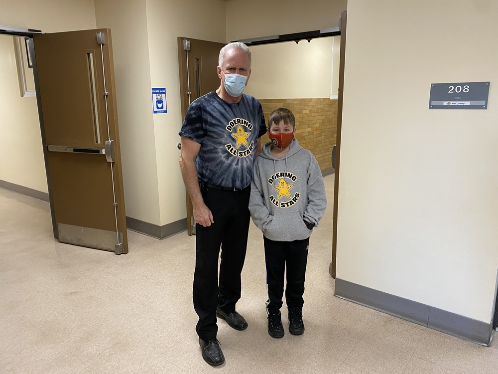 Roberta G. Doering School Principal Tom Schnepp and a student in their All Star gear