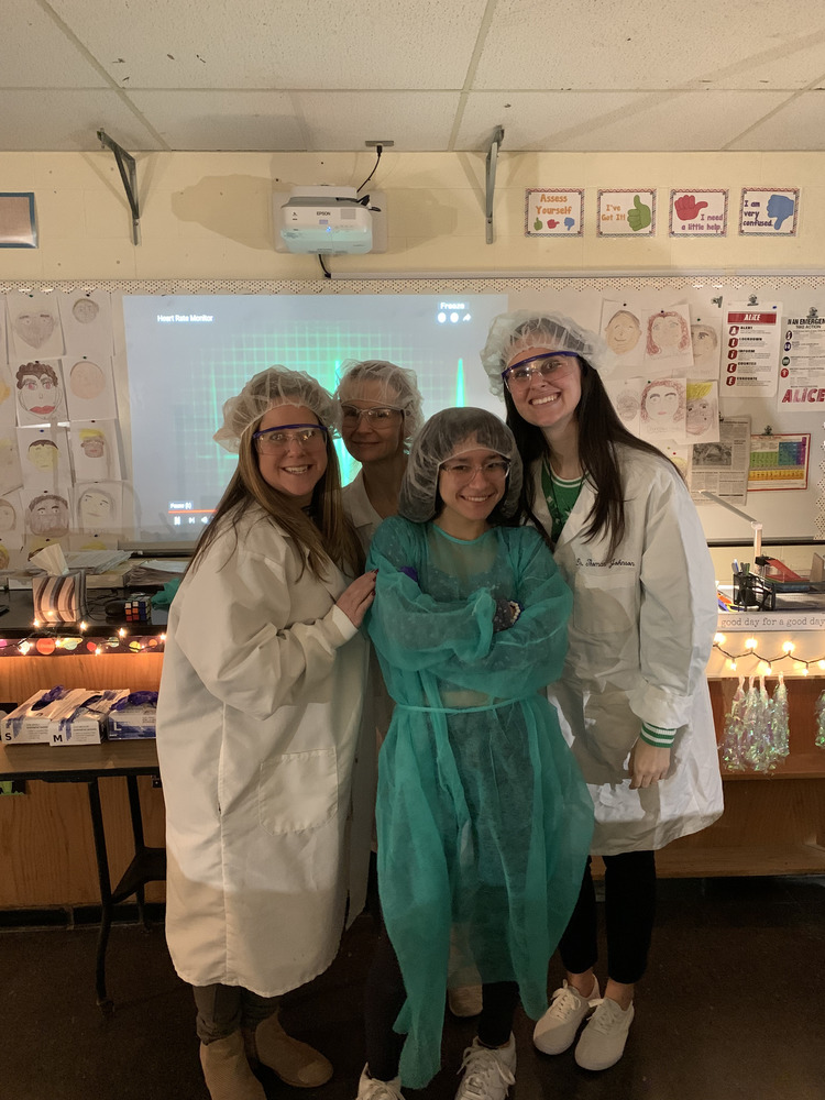teachers and student dressed in lab protective gear