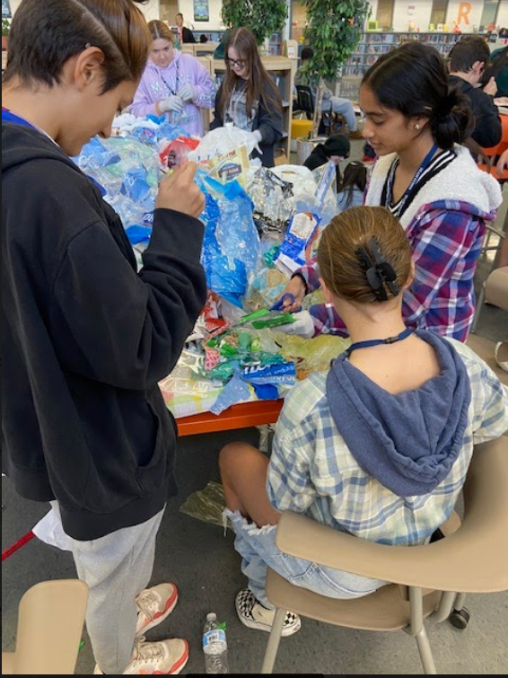 students creating ecobricks from plastic