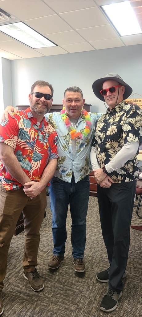 Three administrators in Hawaiian shirts and leis
